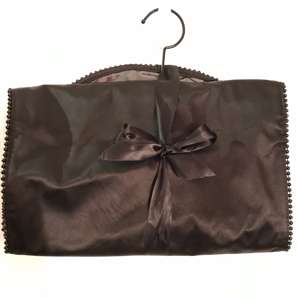 Cosmetic travel bag and black leather like purse.